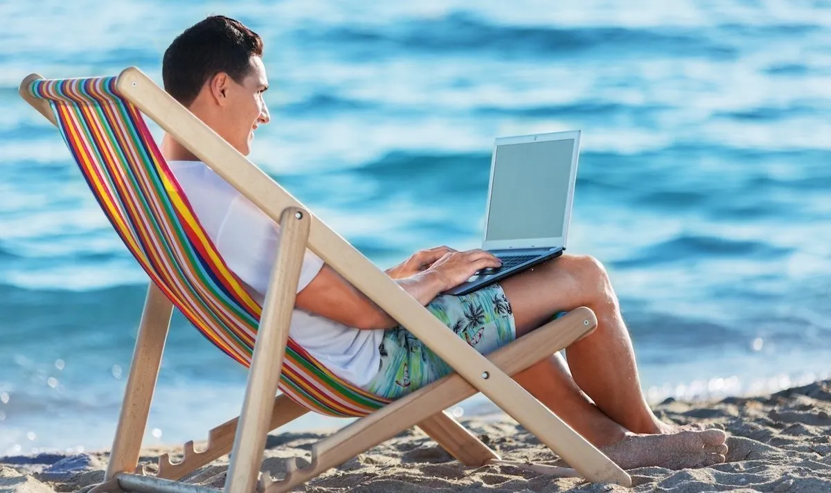 Person closing laptop near window